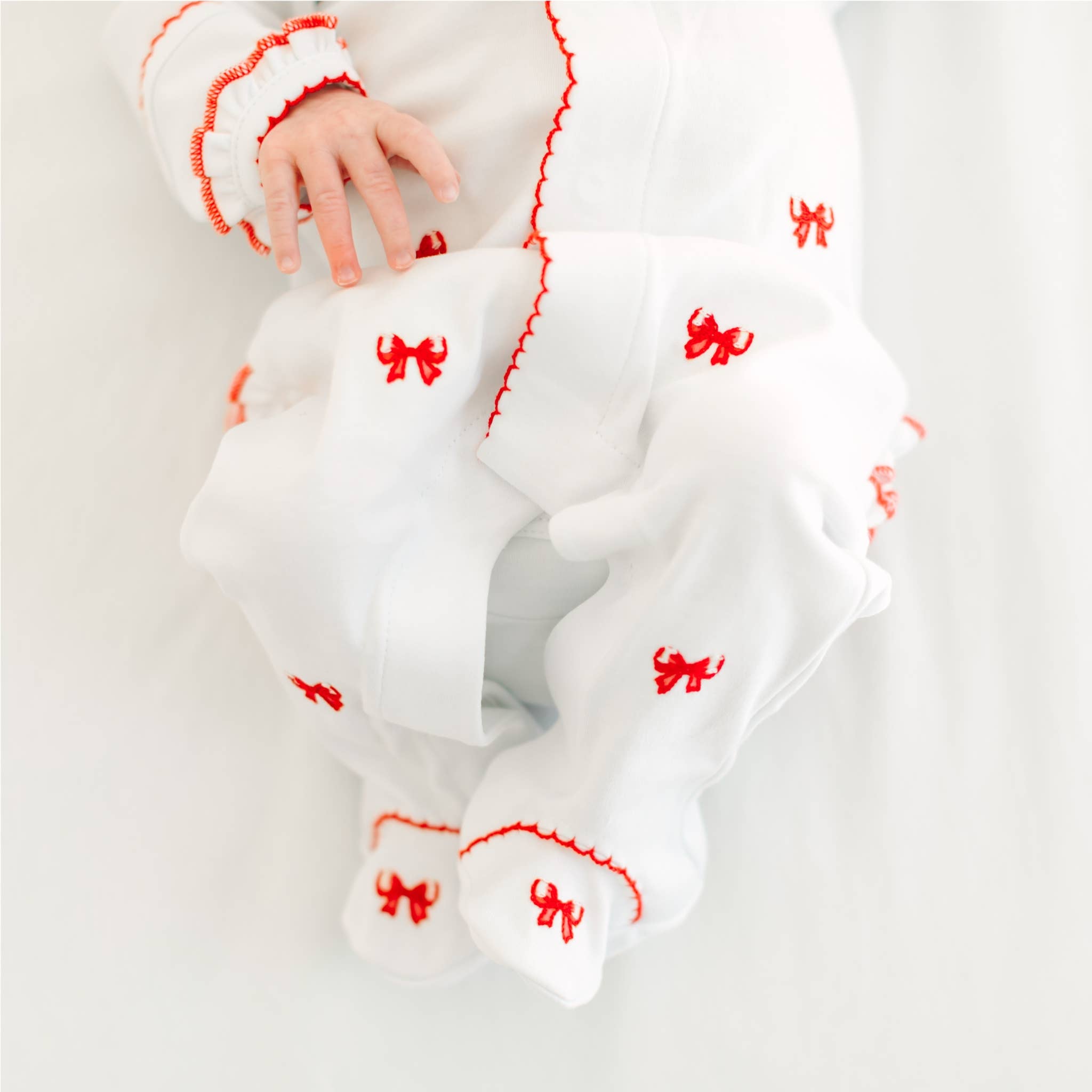 Scarlett Bows Scattered Ruffle Footie: Newborn Magnolia BabyTAYLOR + MAX