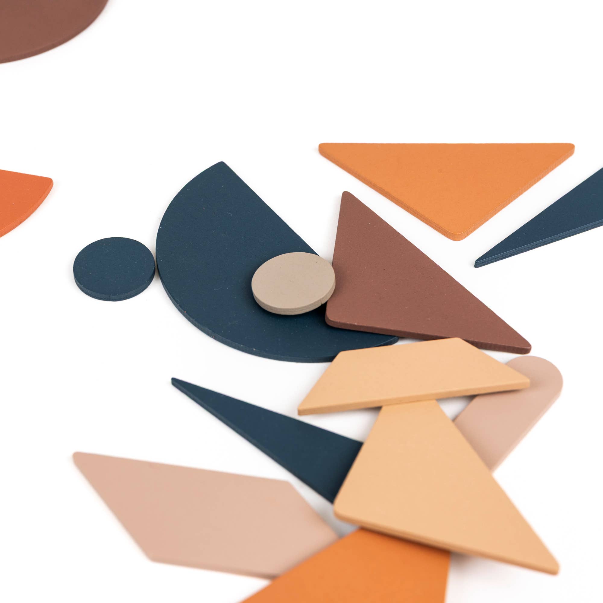 Colorful geometric wooden shapes on a white background